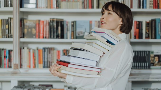 toeic or toefl girl carrying books pile